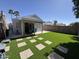 Lush backyard with artificial grass, covered patio, and block fence for a private outdoor oasis at 17406 N 28Th Dr, Phoenix, AZ 85053