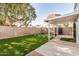 This backyard has faux grass, a patio, and shaded areas at 17406 N 28Th Dr, Phoenix, AZ 85053