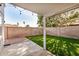 The fenced-in backyard has pavers, faux grass, and covered patio at 17406 N 28Th Dr, Phoenix, AZ 85053