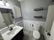 Bright bathroom with a modern vanity, toilet and tiled shower, complemented by stylish wall decor at 17406 N 28Th Dr, Phoenix, AZ 85053