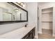 Bathroom featuring a dark vanity with a white countertop and a large mirror at 17406 N 28Th Dr, Phoenix, AZ 85053