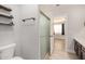 Bathroom with a toilet, glass door walk in shower, vanity, and wood shelving at 17406 N 28Th Dr, Phoenix, AZ 85053