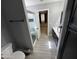 Bathroom showcasing updated fixtures, glass-enclosed shower and an adjacent dressing area at 17406 N 28Th Dr, Phoenix, AZ 85053