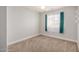 Clean bedroom featuring neutral walls, a ceiling fan, and carpet flooring at 17406 N 28Th Dr, Phoenix, AZ 85053