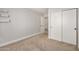 This bedroom features neutral paint, carpet, shelving and a closet with sliding doors at 17406 N 28Th Dr, Phoenix, AZ 85053