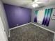 A bright bedroom featuring carpet floors and a window dressed with stylish curtains at 17406 N 28Th Dr, Phoenix, AZ 85053