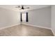 A clean bedroom features neutral walls, baseboards, tile floor, and a ceiling fan at 17406 N 28Th Dr, Phoenix, AZ 85053