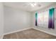 Clean bedroom featuring neutral walls, a ceiling fan, and carpet flooring at 17406 N 28Th Dr, Phoenix, AZ 85053