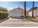 Lovely single-story home featuring a two-car garage, desert landscaping and mature palm trees along the walkway at 17406 N 28Th Dr, Phoenix, AZ 85053
