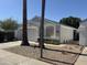 Attractive single-story home featuring a two-car garage, desert landscaping, and mature palm trees at 17406 N 28Th Dr, Phoenix, AZ 85053