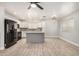 Bright kitchen and dining area with white cabinets, subway tile backsplash, wood-look tile flooring, and stainless appliances at 17406 N 28Th Dr, Phoenix, AZ 85053