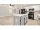 Bright kitchen boasts an island, modern appliances, white cabinetry and backsplash at 17406 N 28Th Dr, Phoenix, AZ 85053