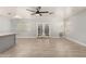 Open-concept living room featuring tile flooring with a combined view of the kitchen and sliding glass doors at 17406 N 28Th Dr, Phoenix, AZ 85053