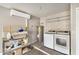 The laundry room is equipped with a washer, dryer, shelving, and storage at 17406 N 28Th Dr, Phoenix, AZ 85053