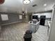 Open living room and kitchen area featuring updated floors, appliances, and modern finishes at 17406 N 28Th Dr, Phoenix, AZ 85053