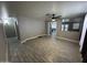 Spacious living room featuring modern wood-look tile flooring and a ceiling fan for comfort at 17406 N 28Th Dr, Phoenix, AZ 85053