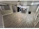 Spacious living room area with updated flooring and an open layout to the kitchen at 17406 N 28Th Dr, Phoenix, AZ 85053