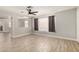 Open concept living area with wood-look tile flooring, a ceiling fan and a neutral color scheme at 17406 N 28Th Dr, Phoenix, AZ 85053