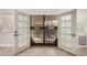 Open white double doors leading to an enclosed patio at 17406 N 28Th Dr, Phoenix, AZ 85053