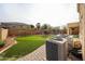 Spacious backyard featuring lush artificial grass, a refreshing pool, and a charming patio area perfect for outdoor entertaining at 17687 W Surrey Dr, Surprise, AZ 85388
