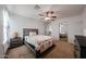 Comfortable bedroom with neutral carpet, ceiling fan, and mirrored closet doors at 17687 W Surrey Dr, Surprise, AZ 85388