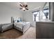 Well-lit bedroom featuring a silver bed frame, carpeted floor, and ceiling fan at 17687 W Surrey Dr, Surprise, AZ 85388