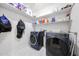 Convenient laundry room with modern appliances and shelving for storage and organization at 17687 W Surrey Dr, Surprise, AZ 85388