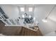 Open-concept living room with high ceilings, modern furniture, and carpeted stairs at 17687 W Surrey Dr, Surprise, AZ 85388