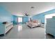 Large main bedroom featuring blue walls, hardwood floors, and a comfortable bed at 17687 W Surrey Dr, Surprise, AZ 85388