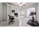Bright office featuring custom built-ins, ceiling fan, and stylish marble flooring at 17687 W Surrey Dr, Surprise, AZ 85388