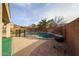 Fenced-in backyard pool with a grill and patio, perfect for outdoor entertaining and relaxation at 17687 W Surrey Dr, Surprise, AZ 85388
