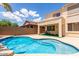 Backyard pool with a well-maintained patio and lush landscaping at 17687 W Surrey Dr, Surprise, AZ 85388