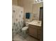 Clean bathroom with tile floors, vanity with storage, large mirror, and a shower with tub at 17821 N Woodrose Ave, Surprise, AZ 85374