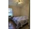 Comfortable bedroom with laminate floors, a window, and a ceiling fan at 17821 N Woodrose Ave, Surprise, AZ 85374
