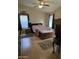 Cozy main bedroom with a ceiling fan, natural light, and an ensuite bathroom at 17821 N Woodrose Ave, Surprise, AZ 85374