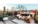 An inviting backyard oasis featuring desert landscape, fireplace and outdoor seating area at 1936 W Kinfield Trl, Phoenix, AZ 85085