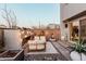 Relax in this backyard with a lounge area, unique fireplace and desert landscaping at 1936 W Kinfield Trl, Phoenix, AZ 85085