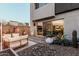 The backyard has a lounge area near the sliding doors and desert landscaping at 1936 W Kinfield Trl, Phoenix, AZ 85085