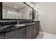 Modern bathroom featuring a dual sink vanity with granite countertop and glass-enclosed shower at 1936 W Kinfield Trl, Phoenix, AZ 85085