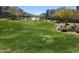 Landscaped community lawn with lush green grass and modern homes under a clear blue sky at 1936 W Kinfield Trl, Phoenix, AZ 85085