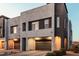 Modern home exterior features a two-car garage and contemporary design at 1936 W Kinfield Trl, Phoenix, AZ 85085