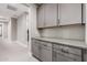 Hallway features grey cabinets and drawers with light grey countertop at 1936 W Kinfield Trl, Phoenix, AZ 85085