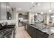 Open concept kitchen featuring stainless steel appliances, gray cabinets, and granite countertops at 1936 W Kinfield Trl, Phoenix, AZ 85085