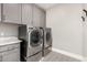 Convenient laundry room with modern washer and dryer, plus ample cabinet space at 1936 W Kinfield Trl, Phoenix, AZ 85085