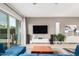 Modern living room with large sliding doors, hardwood floors, TV, and a blue sofa at 1936 W Kinfield Trl, Phoenix, AZ 85085