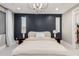 The main bedroom has a navy accent wall, a chandelier, and carpeted floors at 1936 W Kinfield Trl, Phoenix, AZ 85085