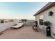 Relaxing roof deck with a sunbed, dining table, and string lights at 1936 W Kinfield Trl, Phoenix, AZ 85085
