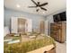 Bedroom boasts a ceiling fan, TV, closet, and natural light from the windows at 20515 N 271St Ave, Buckeye, AZ 85396