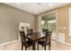 Well-lit dining area with a dark wood table, matching chairs, and sliding glass door at 20515 N 271St Ave, Buckeye, AZ 85396