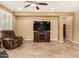 Comfortable living room featuring a large TV, tile flooring, and neutral paint at 20515 N 271St Ave, Buckeye, AZ 85396